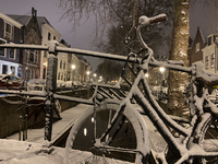 900628 Gezicht op de besneeuwde Nieuwegracht te Utrecht, vanaf de Magdalenabrug, bij avond.